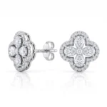 Diamond cluster stud earrings with a four-leaf clover design and halo of small diamonds on white gold or platinum setting.