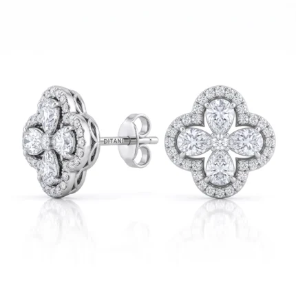 Diamond cluster stud earrings with a four-leaf clover design and halo of small diamonds on white gold or platinum setting.
