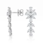 Diamond-studded drop earring with a floral motif of marquise-cut stones in a cascading design, set in white metal.