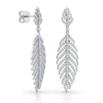 Diamond-leaf drop earrings in silver with pavé diamonds, shown from side and front. Elegant, fern-inspired dangle jewelry.