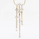 Gold necklace with a vertical, multi-bar pendant set with clear rectangular and round diamonds against a white background