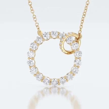 Gold pendant with an interlocking pair of diamond-studded circles on a delicate gold chain.