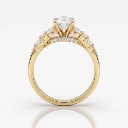 Gold engagement ring featuring a large round center diamond in a prong setting with baguette diamonds along the shoulders and pavé stones on the band