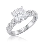 Engagement ring with a large round center diamond and pavé-set diamonds along the shoulders; band engraved with DITANI.