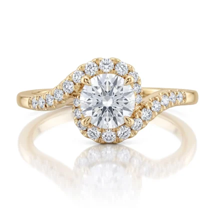 Yellow gold ring with a large round center diamond surrounded by a halo of smaller diamonds on a curved band.