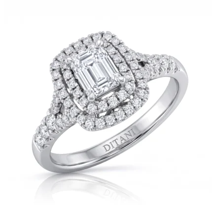 Emerald-cut center diamond surrounded by twin halos of pavé diamonds on a diamond-studded white-gold band, engraving inside.