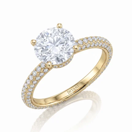 Gold ring with a large round-cut diamond solitaire set in four prongs, flanked by pavé diamonds along the band, engraved 'DITANI' on the inner band.