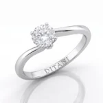 Silver engagement ring with a round-cut diamond held by four prongs on a polished band, inner engraving reads DITANI