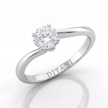 Silver engagement ring with a round-cut diamond held by four prongs on a polished band, inner engraving reads DITANI
