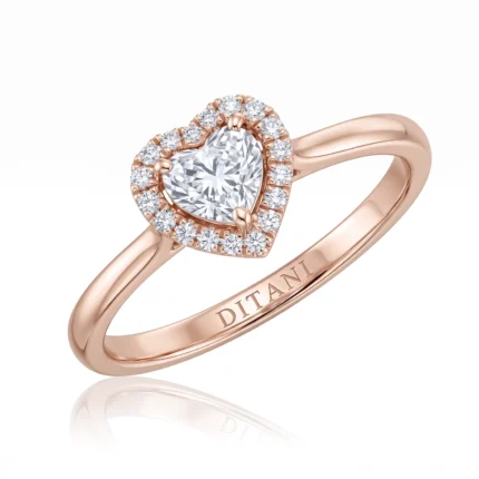 Rose-gold ring with a central diamond encircled by a halo of smaller diamonds in a heart shape; band engraved DITANI.