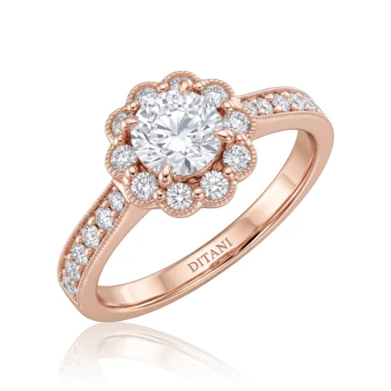 Rose gold engagement ring with a large central diamond surrounded by a flower-shaped halo and diamond-accented band on the shoulders.