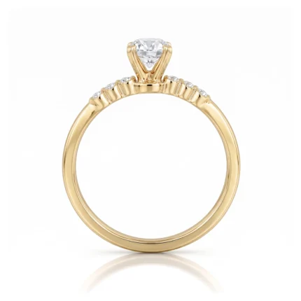 Gold engagement ring with a central round diamond and small side stones set in a yellow gold band.