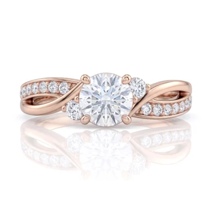Rose gold engagement ring with a round center diamond and pavé diamonds along the twisted band.