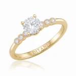 Gold ring with a large central diamond and small diamond accents along a curved band, inner engraving reads DITANI