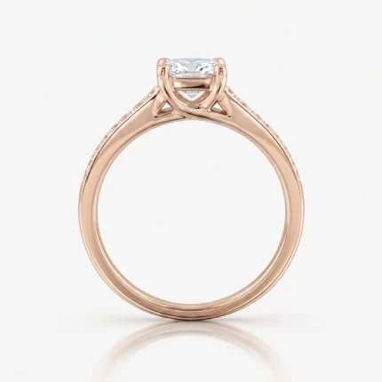 Rose gold engagement ring with a rectangular emerald-cut center diamond and pavé-set shoulders along a slim band.