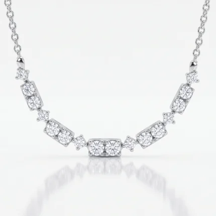 Silver necklace with diamond settings along a chain, displayed in a curved shape against a pale background.