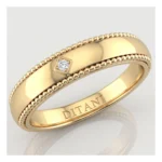 Gold ring with a beaded edge and a smooth central band, featuring a small square-cut diamond set on the side and 'DITANI' engraved inside.