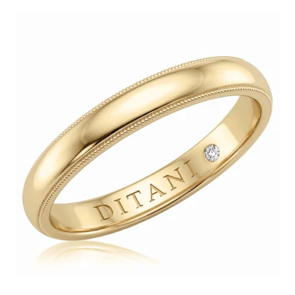 Gold ring with a beaded edge, inner engraving 'DITANI' and a small diamond on the outer side.