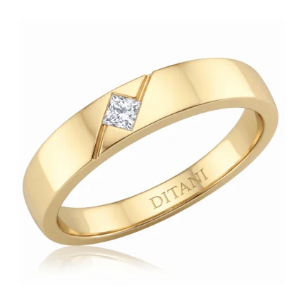 Yellow gold band with a small square-cut diamond set in a diagonal notch and inner engraving visible on the inner rim.