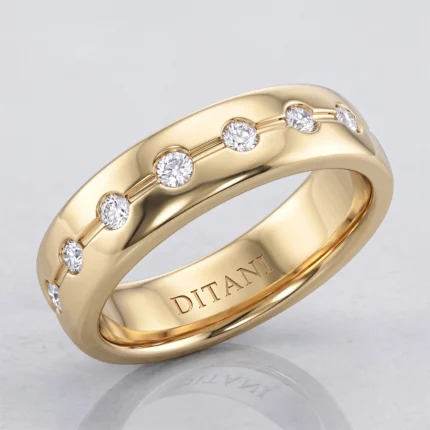 Gold ring with a row of small diamonds set along the top half of the band, polished finish