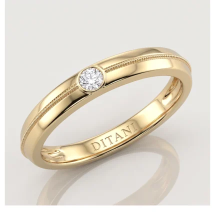 Gold ring with a single round diamond in a bezel setting and a beaded edge, inner band engraved 'DITANI'