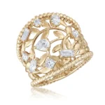 Gold ring with a leafy vine design and multiple diamond stones set along the band, decorative beaded edge visible in gold