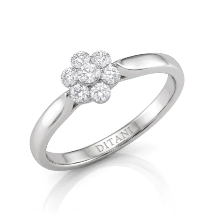 Silver ring featuring a seven-diamond flower cluster on a polished band, with engraving inside the shank.