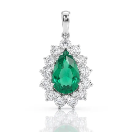 Teardrop emerald pendant surrounded by a halo of diamonds in a silver setting on a pendant