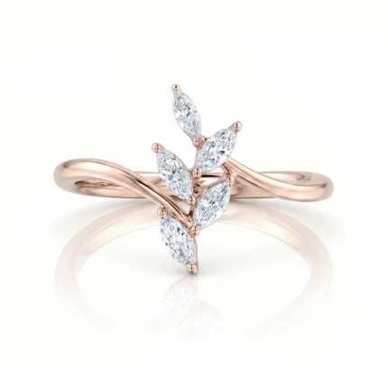 Rose gold ring with a leaf-like cluster of marquise-cut diamonds on a curved band, photographed against a white background.