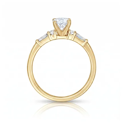 Gold engagement ring with a large central diamond and two baguette side stones on a polished band, against a white backdrop.
