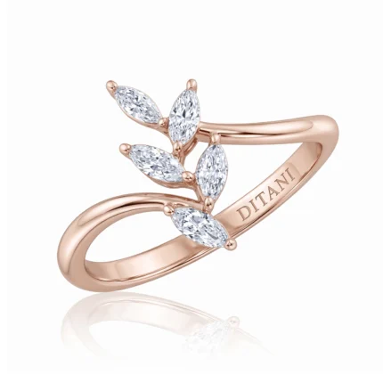 Rose gold ring with a three-leaf sprig of marquise-cut diamonds along a split shank.