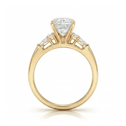 Gold engagement ring with a large central diamond and smaller baguette diamonds along the band, set in a prong setting.