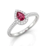Pear‑cut pink ruby ring with a diamond halo set in white gold, band encrusted with pavé diamonds.