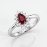 Oval red ruby halo ring with surrounding diamonds on a polished silver band; 'DITANI' engraved inside the band.