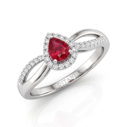Pear-cut red gemstone engagement ring with a halo of small diamonds, set in a white metal band with pavé diamonds along the shank (brand: DITANI)