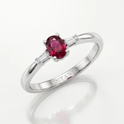 Silver ring with an oval red gemstone and diamond accents, inner band engraved with TITANIT