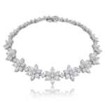 Diamond-studded floral bracelet with clustered flower motifs on a white background, close-up view