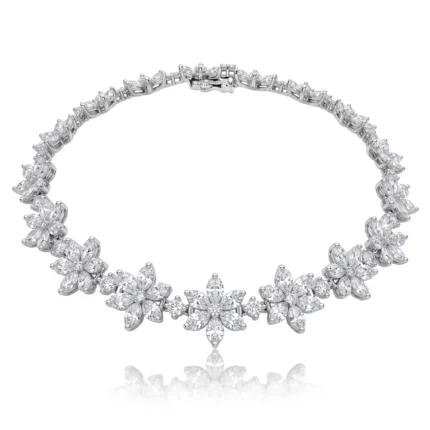 Diamond-studded floral bracelet with clustered flower motifs on a white background, close-up view