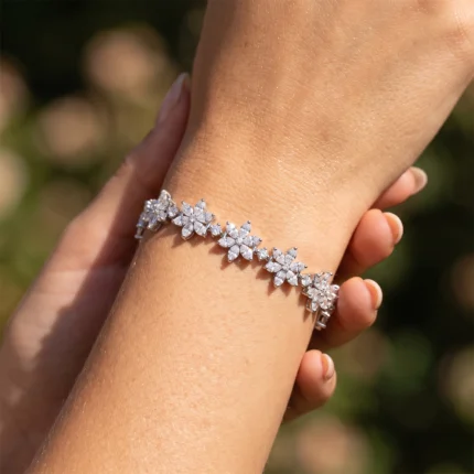 Diamond flower bracelet on a wrist, sparkling in sunlight.