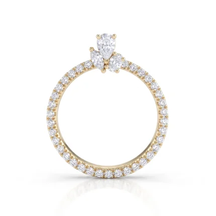 Gold ring with a diamond-encrusted band and a three-stone top setting of pear-cut diamonds.