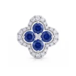 Four-leaf clover-shaped ring with four round blue sapphires surrounded by diamonds in a silver setting, jewelry accessory.
