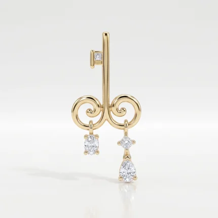 Gold key-shaped pendant with spiral curls and three diamond drop charms (one square-cut, one teardrop) on a light background.