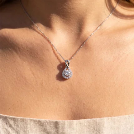 Diamond-studded teardrop pendant necklace on a woman's neck