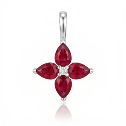 Cross-shaped pendant with four pear-cut red rubies around a central diamond set in silver