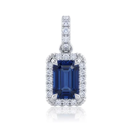 Pendant with a large rectangular blue gemstone surrounded by a diamond halo in a silver setting.