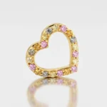 Gold heart-shaped ring encrusted with multicolored round gemstones along the outline on a white background.
