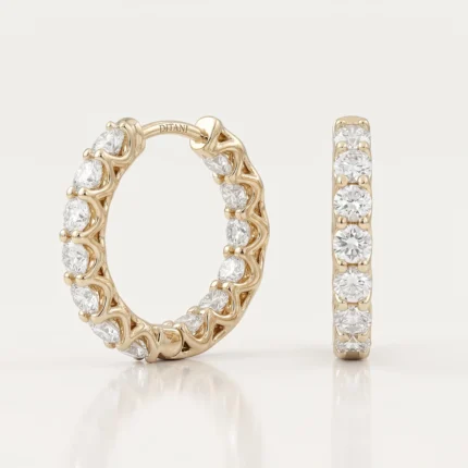 Gold hoop earrings and a matching diamond-studded ring displayed side by side on a light background.