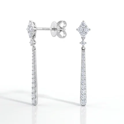 Elegant diamond drop earrings in white gold with a vertical row of pavé-set stones and a diamond cluster stud; one earring shown from the side, the other from the front.