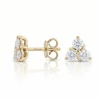 Gold stud earrings in yellow gold featuring a three-diamond cluster (three round-cut diamonds) with screw-back posts by Ditani