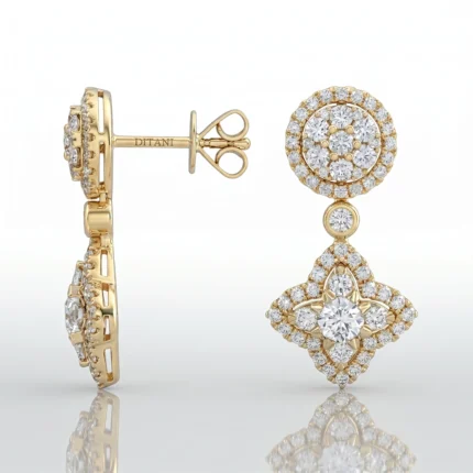Gold drop earrings with diamond halos; circular top and hanging diamond-encrusted motif beneath.